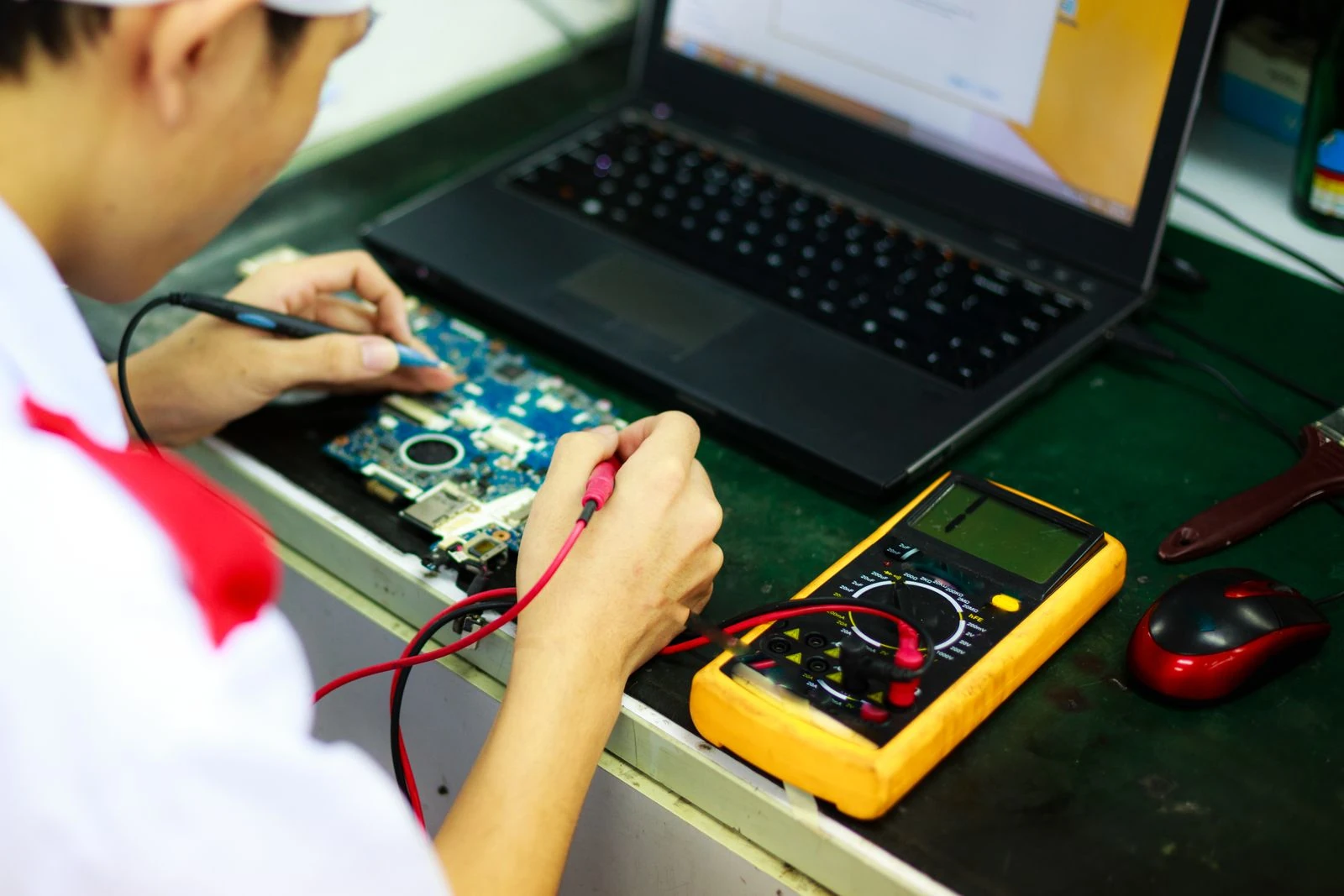 A technician repairing a laptop, warranty and emergency on-site support