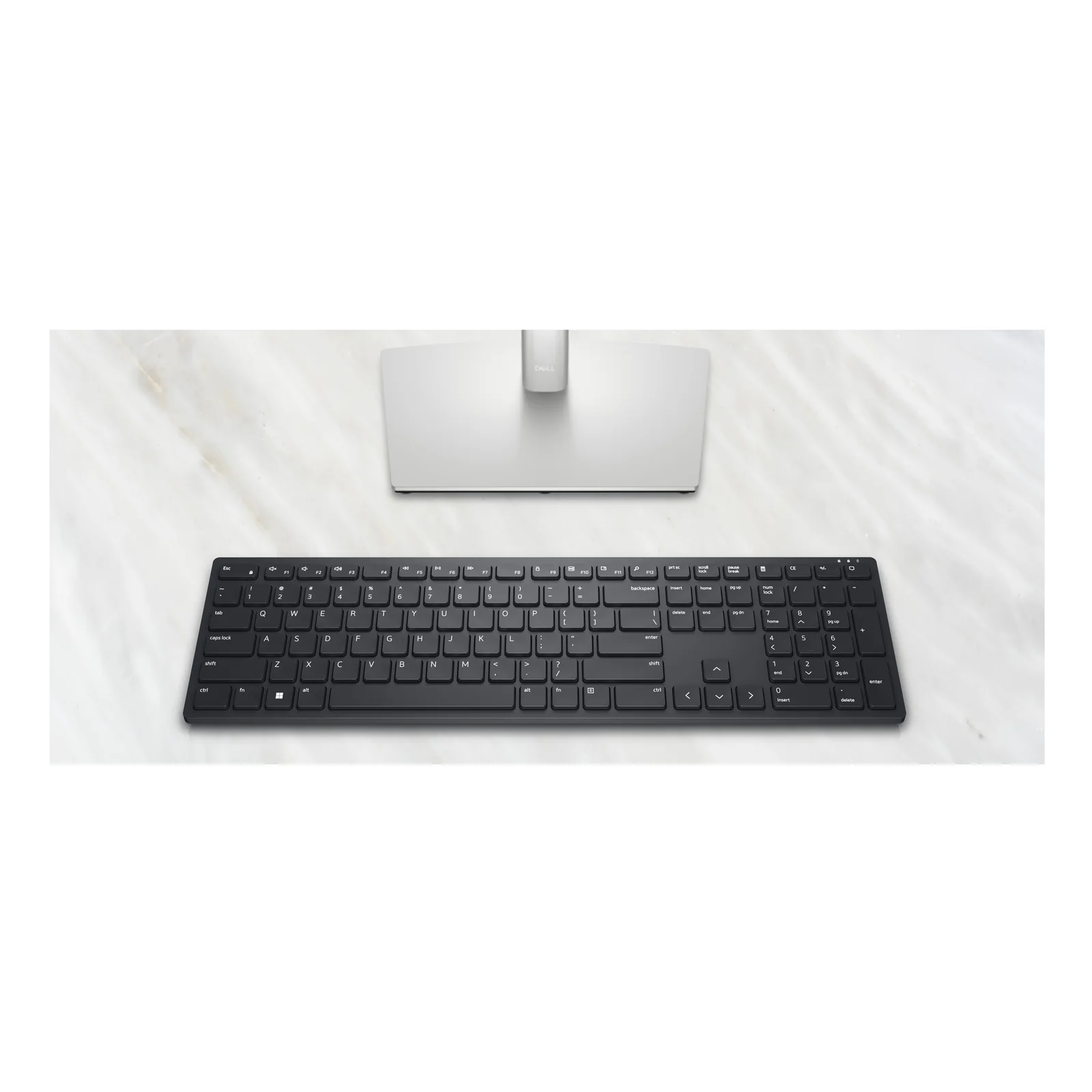 Clavier Dell KB500 noir posé devant un moniteur Dell sur surface en marbre blanc