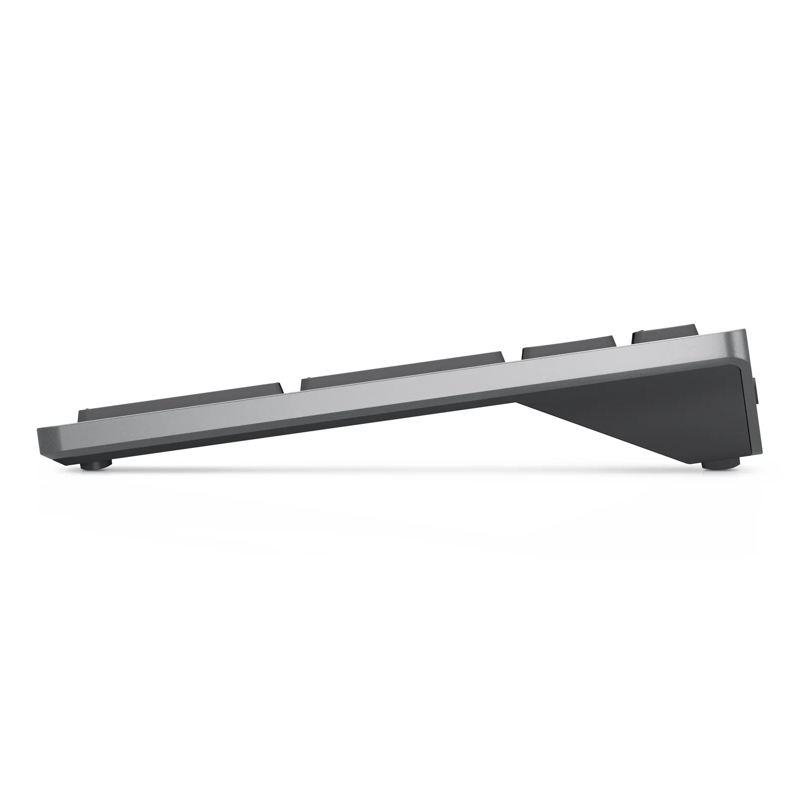 Vue de profil gauche du clavier Dell KM7120W, faible épaisseur visible, gris titane