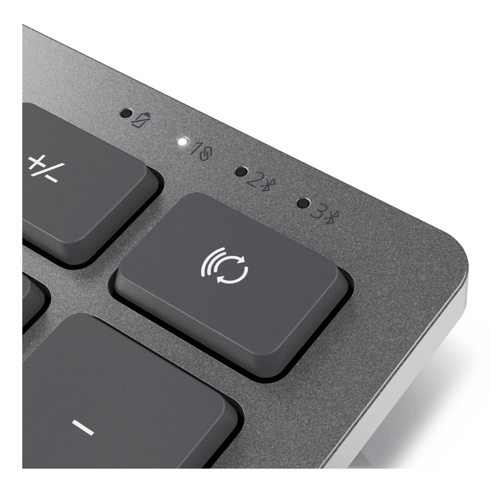 Gros plan sur le coin supérieur droit du clavier KM7120W, touche de bascule et voyants LED