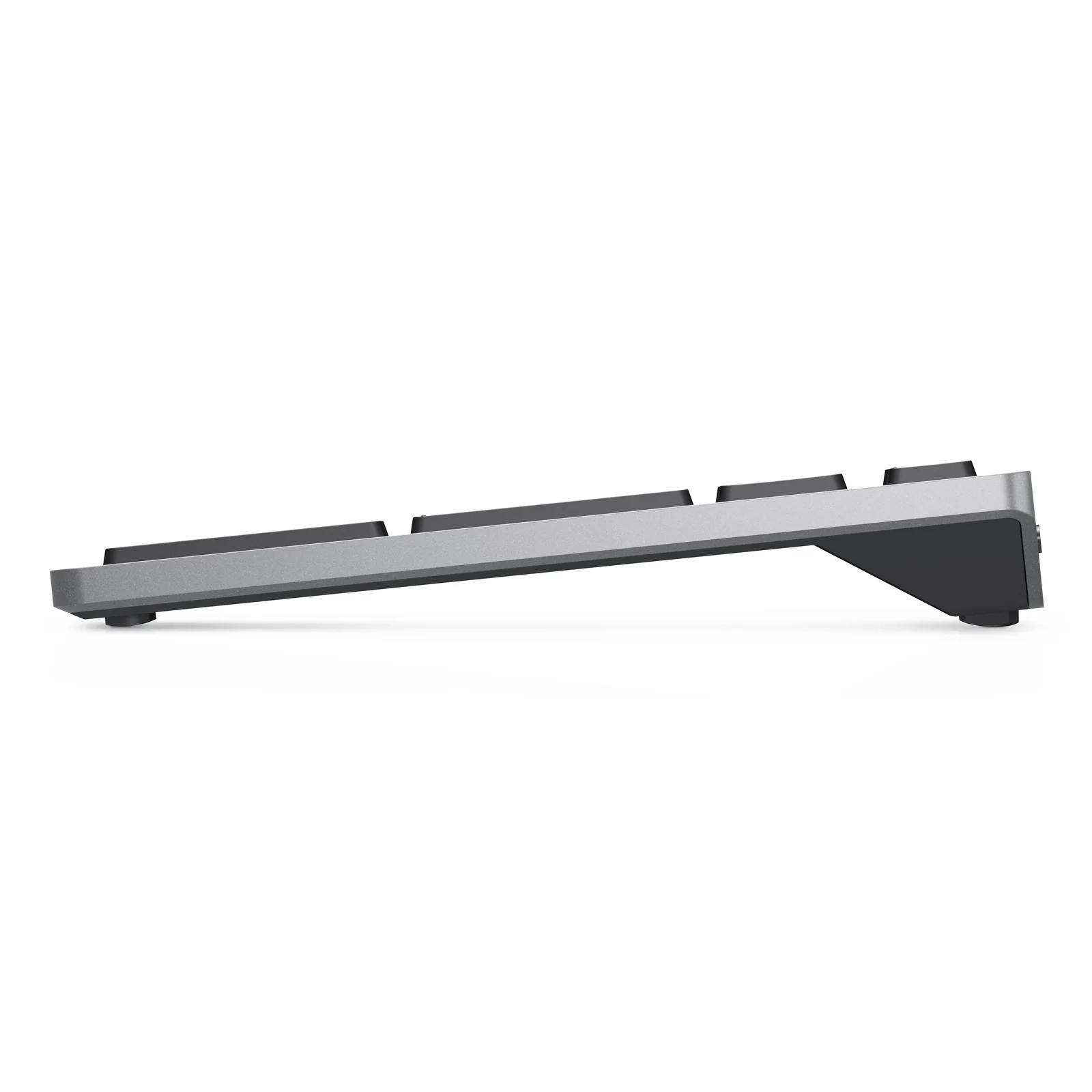 Vue de profil du clavier gris titane, châssis aluminium fin et pieds arrière repliés
