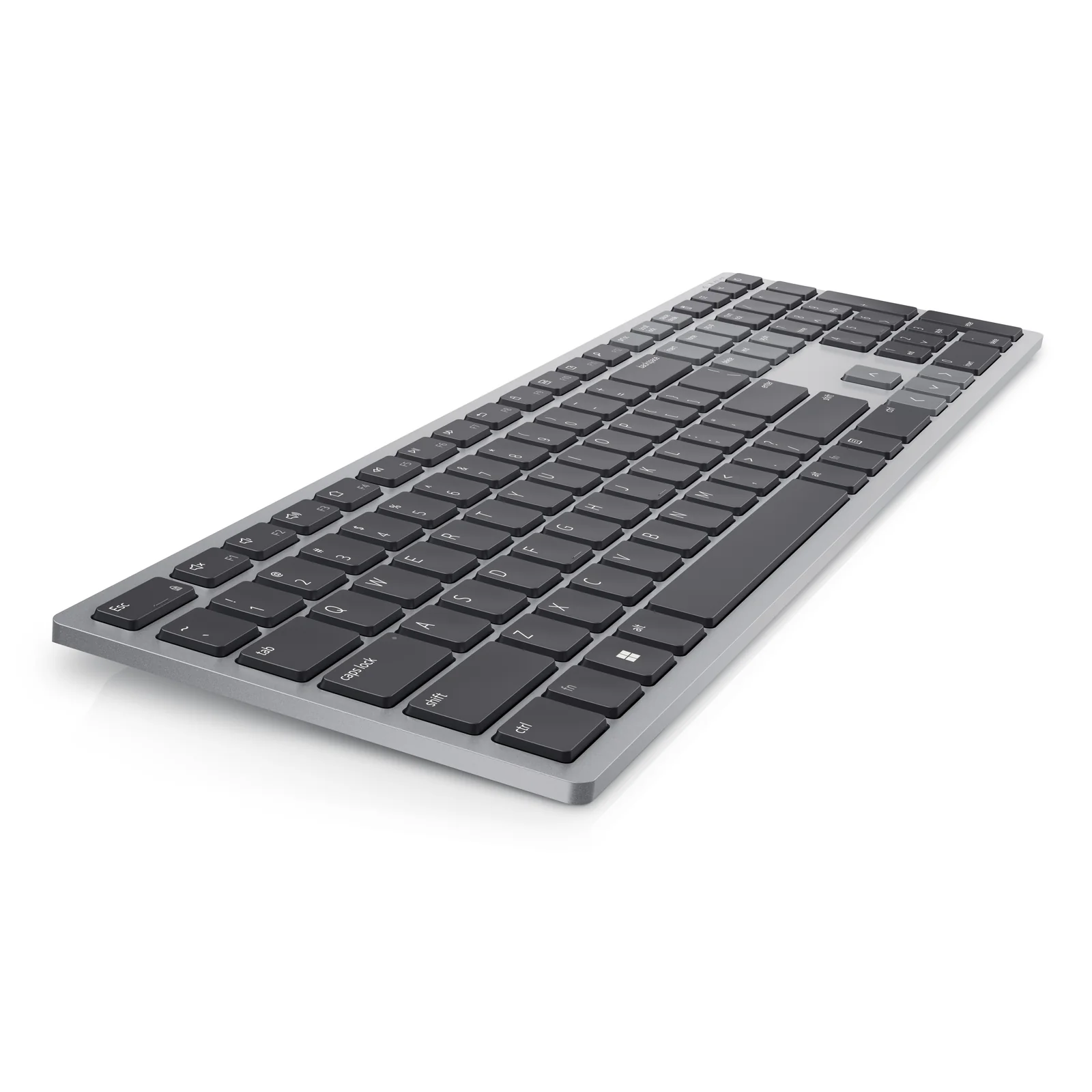 Vue trois-quarts du clavier gris montrant la finesse du châssis aluminium et les touches noires en relief
