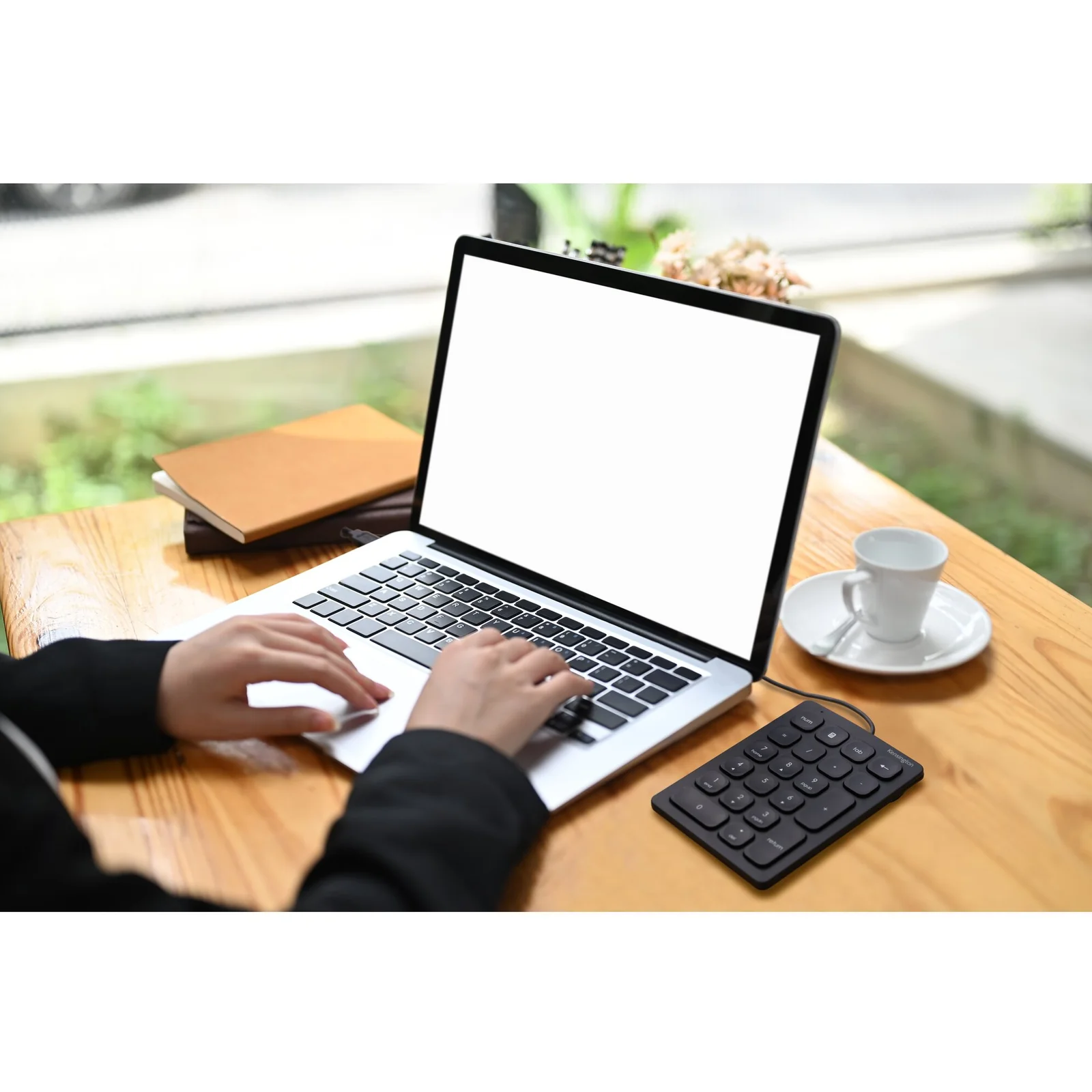 Personne utilisant un laptop avec le pavé numérique Kensington à proximité