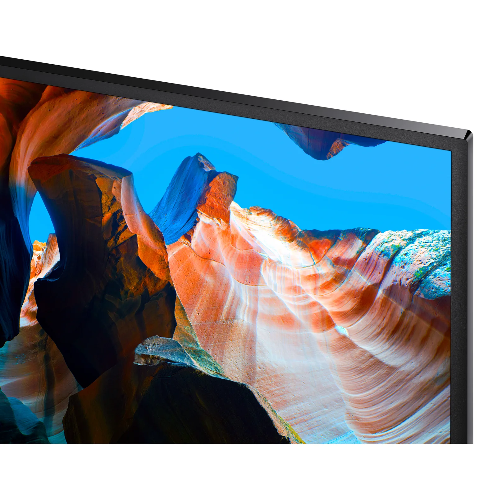 Détail de l'angle supérieur gauche du Samsung UJ59, bordure très fine, image vive de canyon visible