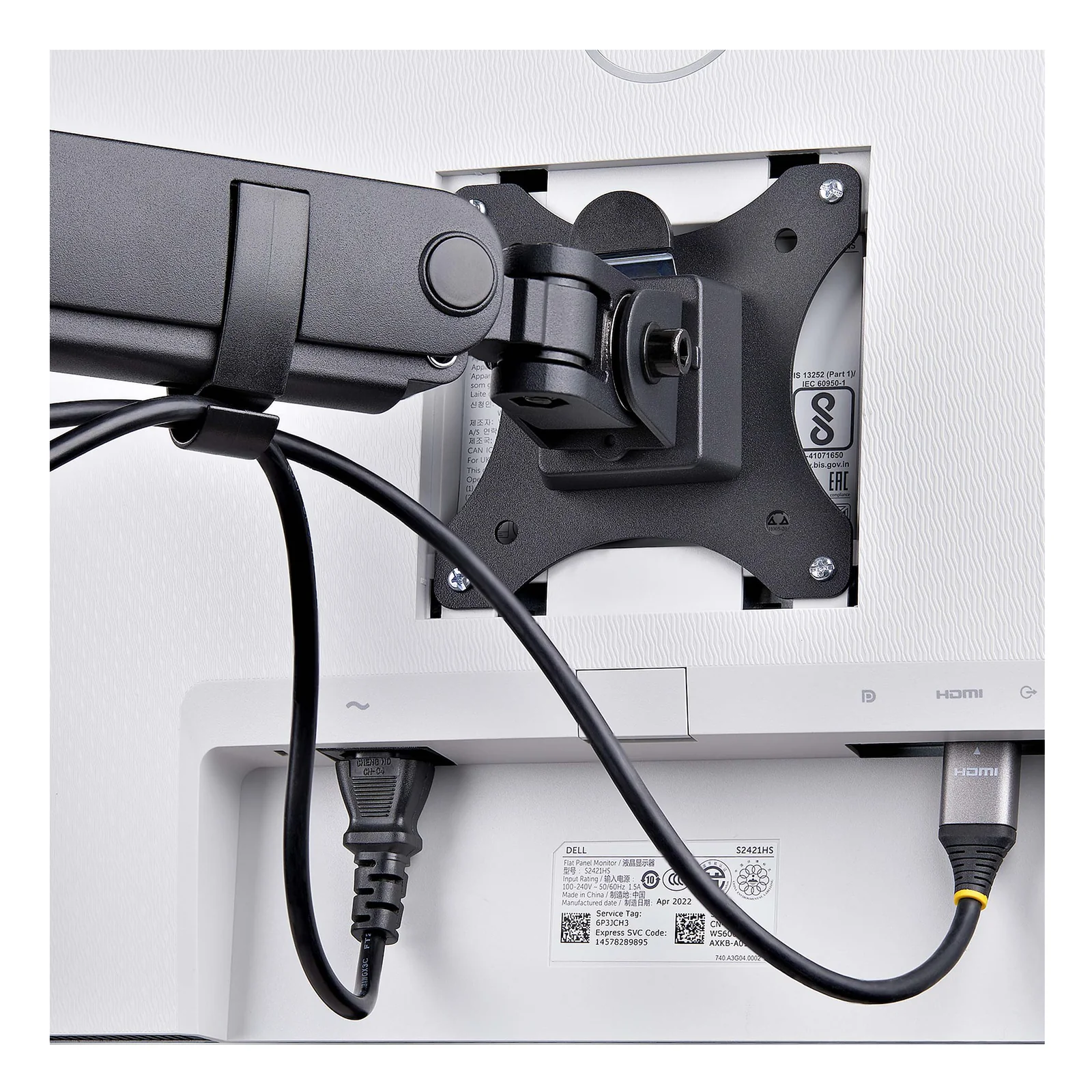 Gros plan sur la plaque VESA fixée au dos d'un écran Dell, câble HDMI inséré et mécanisme de dégagement rapide de la plaque visible.