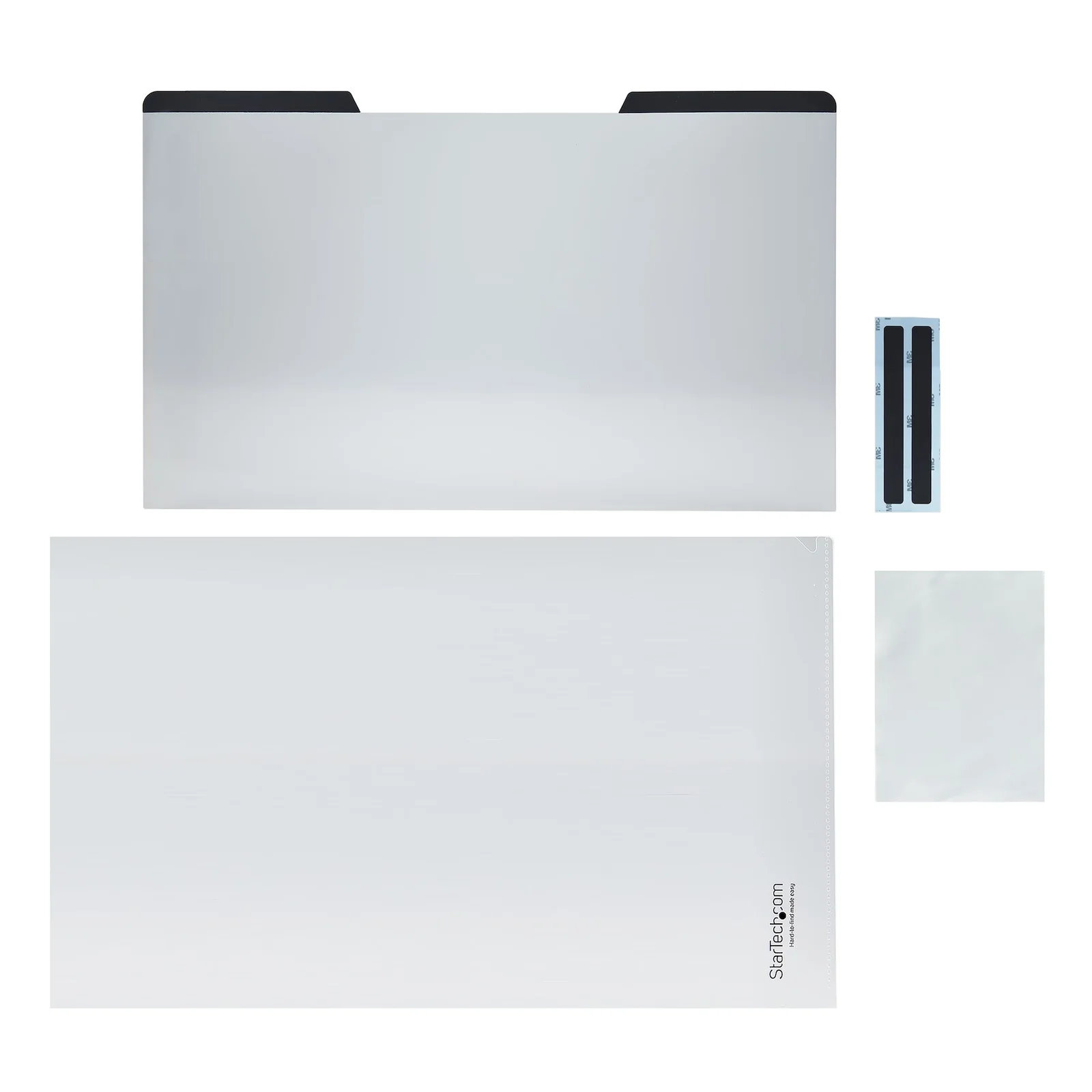 Vue à plat du contenu de la boîte, filtre principal, housse de rangement, bandelettes magnétiques adhésives et chiffon de nettoyage